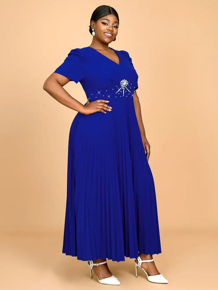 This elegant blue dress features soft fabric and a flattering silhouette making it a perfect short sleeve outfit for spring weddings