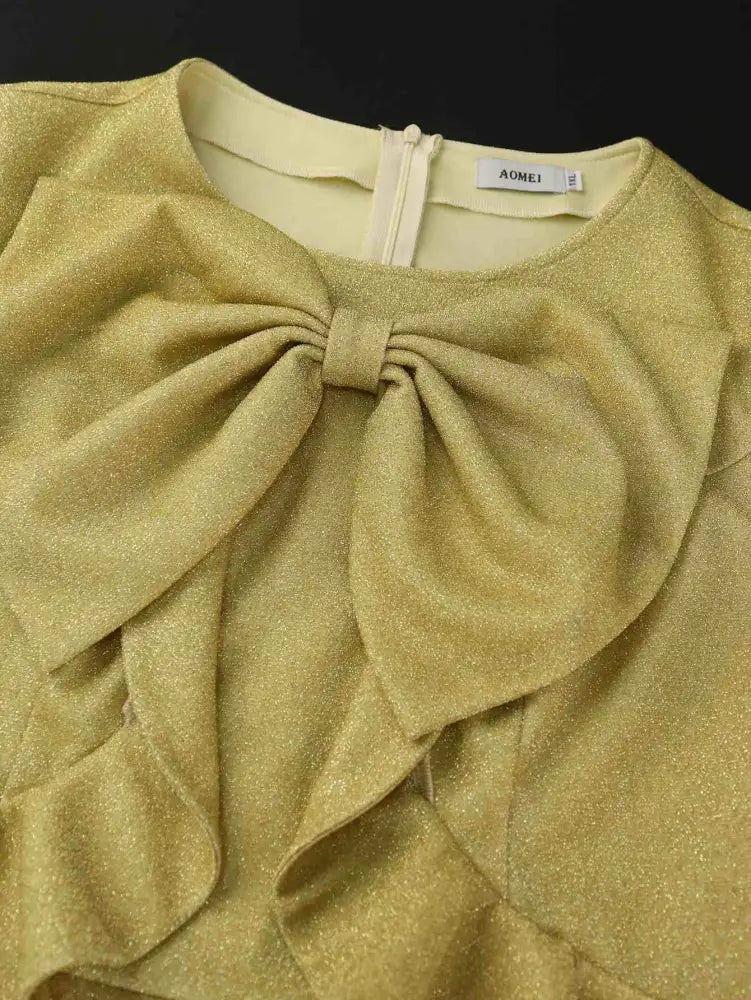 This elegant gold piece is perfect for spring dresses for wedding or trendy plus size dresses for wedding guest with flattering ruffles and puff sleeves

